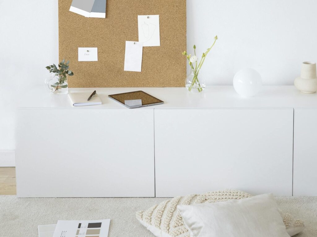 Bright and modern minimalist workspace with cork board for inspiration and creativity.